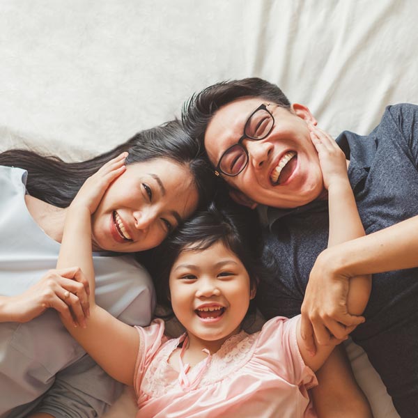 smiling family of three