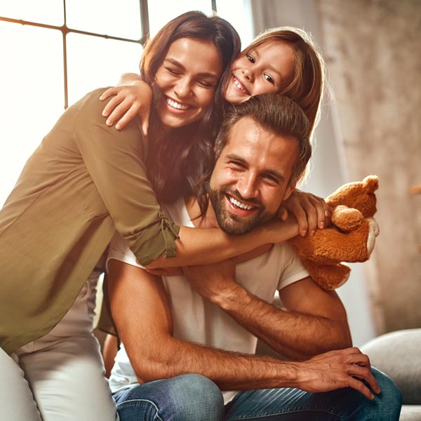 smiling family of three